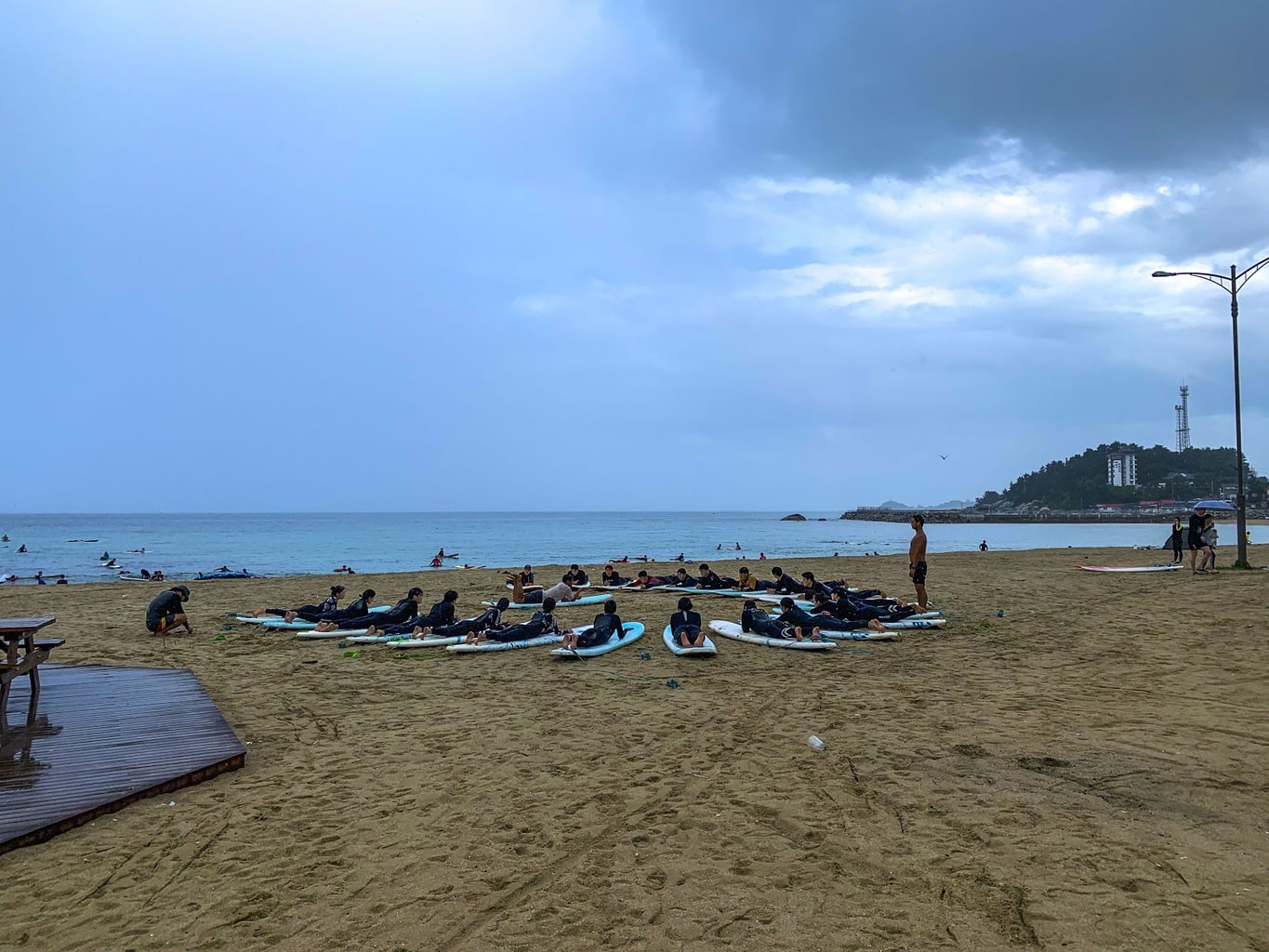Surf class at Ingu Beach on a stormy Summer day